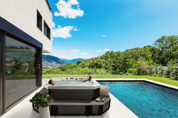 Lush, mountain side view from modern villa with a pool